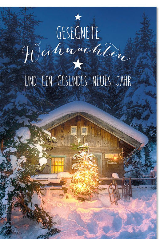Weihnachtskarte mit verschneiter Berghütte und leuchtendem Weihnachtsbaum stimmungsvolle Grußkarte für besinnliche Weihnachten und Neujahrsgrüße