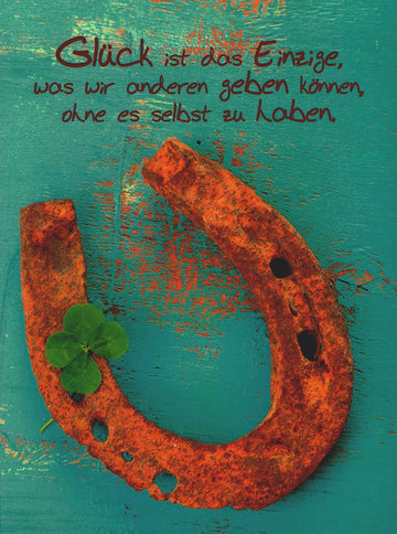 Viel - Glück - Karte mit Hufeisen und Kleeblatt auf türkisfarbenem Holz, inspirierender Spruch für positive Wünsche und Glücksmomente