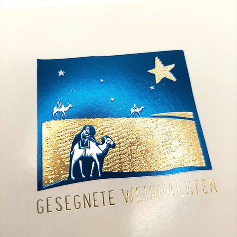 Weihnachtskarte mit heiligem Stern und Reisenden auf der Wüstenlandschaft