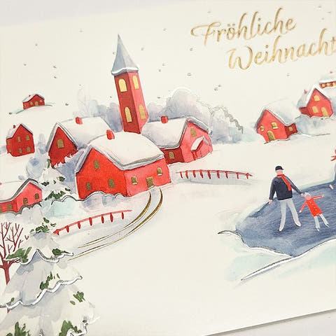 Weihnachtskarte mit idyllischem Winterdorf und fröhlichen Schlittschuhläufern