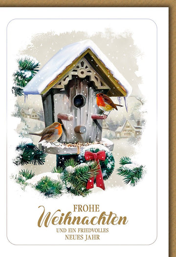 Weihnachtskarte Tiere – Rotkehlchen am Vogelhaus mit verschneiter Winterlandschaft
